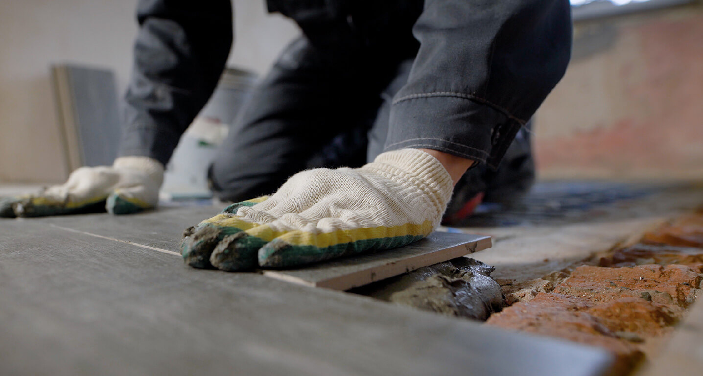 tile floor installer on knees