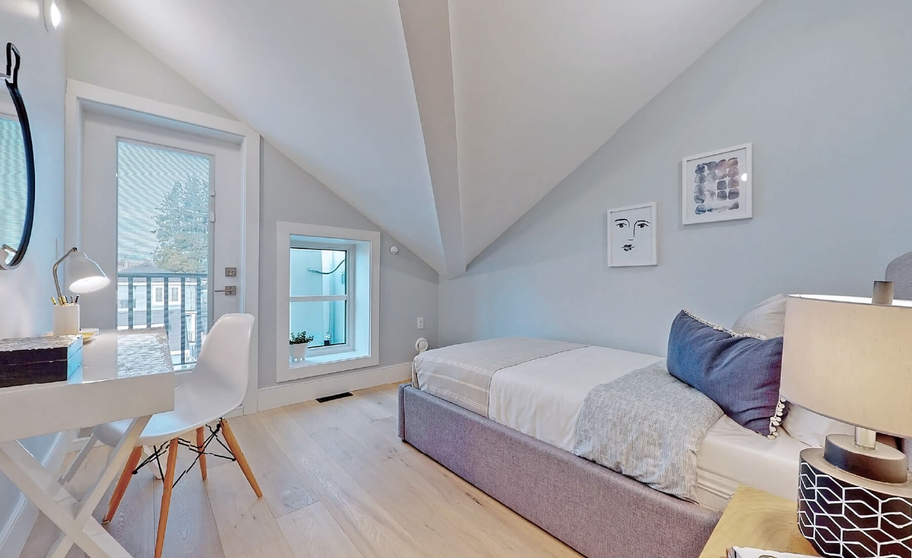 small bedroom with roof trust ceiling, furnished with bed
