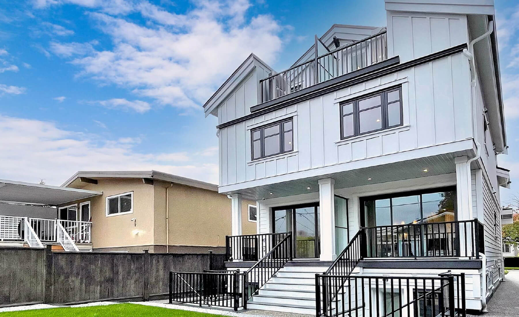 back exterior of Vancouver duplex. White siding, black trim