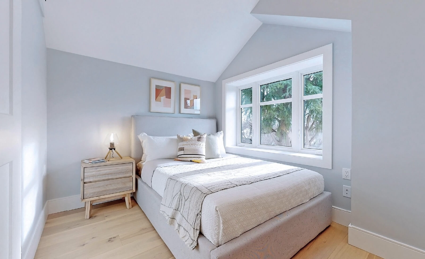 bedroom with bed and side table. south facing window